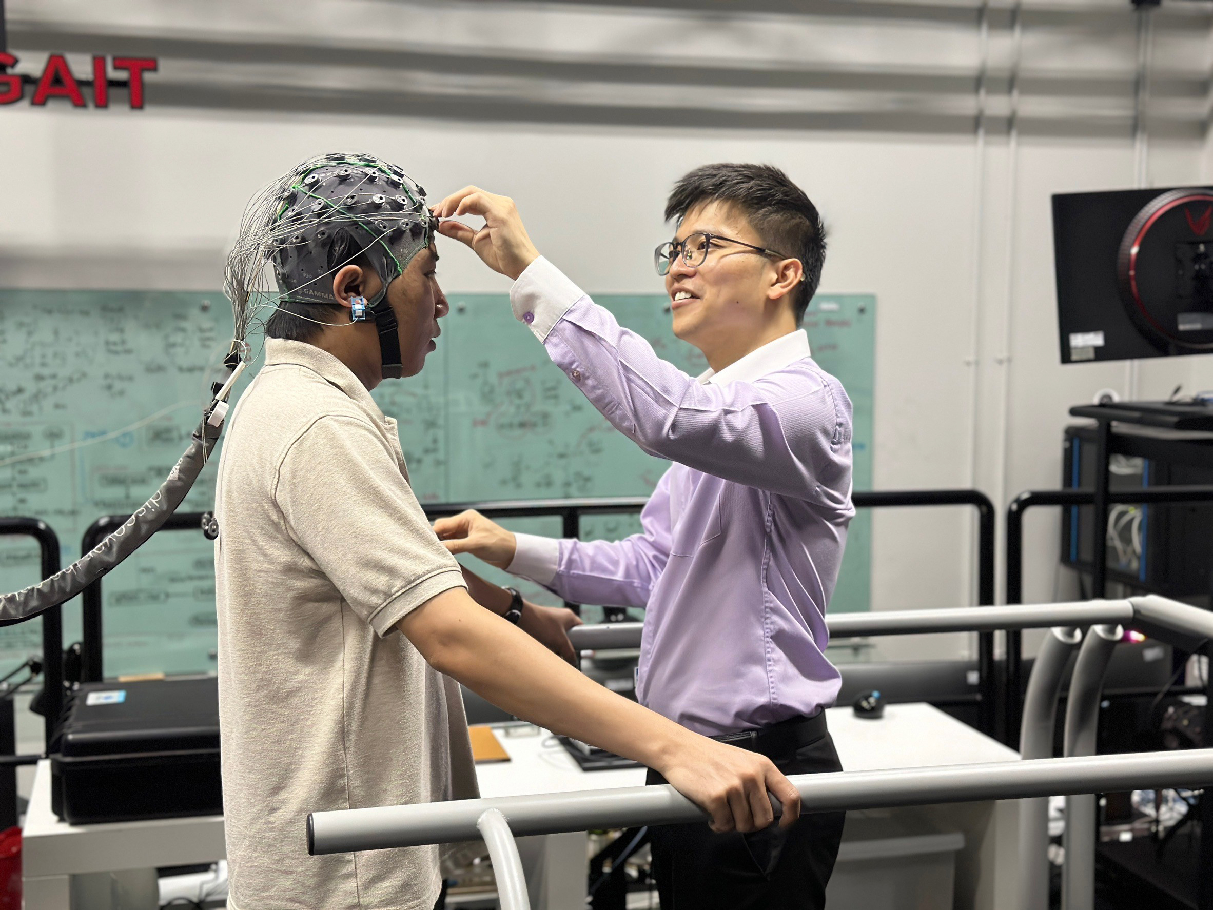Researcher fitting an EEG cap for a brain-computer interface experiment